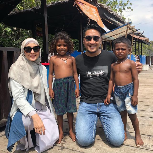 Fenita dan Arie bersama Noni dan Bonny, anak-anak asli Tanah Papua. (dok. Instagram @fenitarie/https://www.instagram.com/p/B54MVRhlTVR//Adhita Diansyavira)