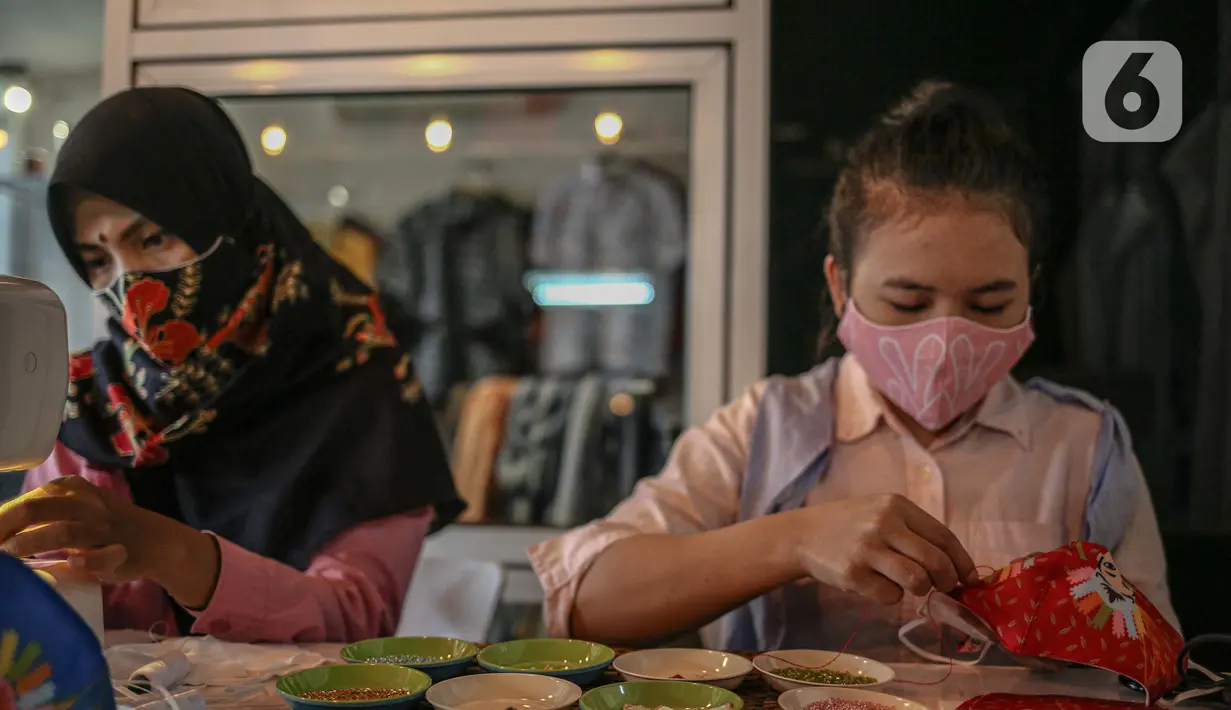 Perajin menyelesaikan pembuatan masker batik di Butik Elemwe, Jakarta, Jumat (2/10/2020). Badan Standardisasi Nasional (BSN) mengeluarkan spesifikasi masker kain ber-SNI yang terbagi menjadi tiga tipe berdasarkan penggunaannya. (Liputan6.com/Faizal Fanani)