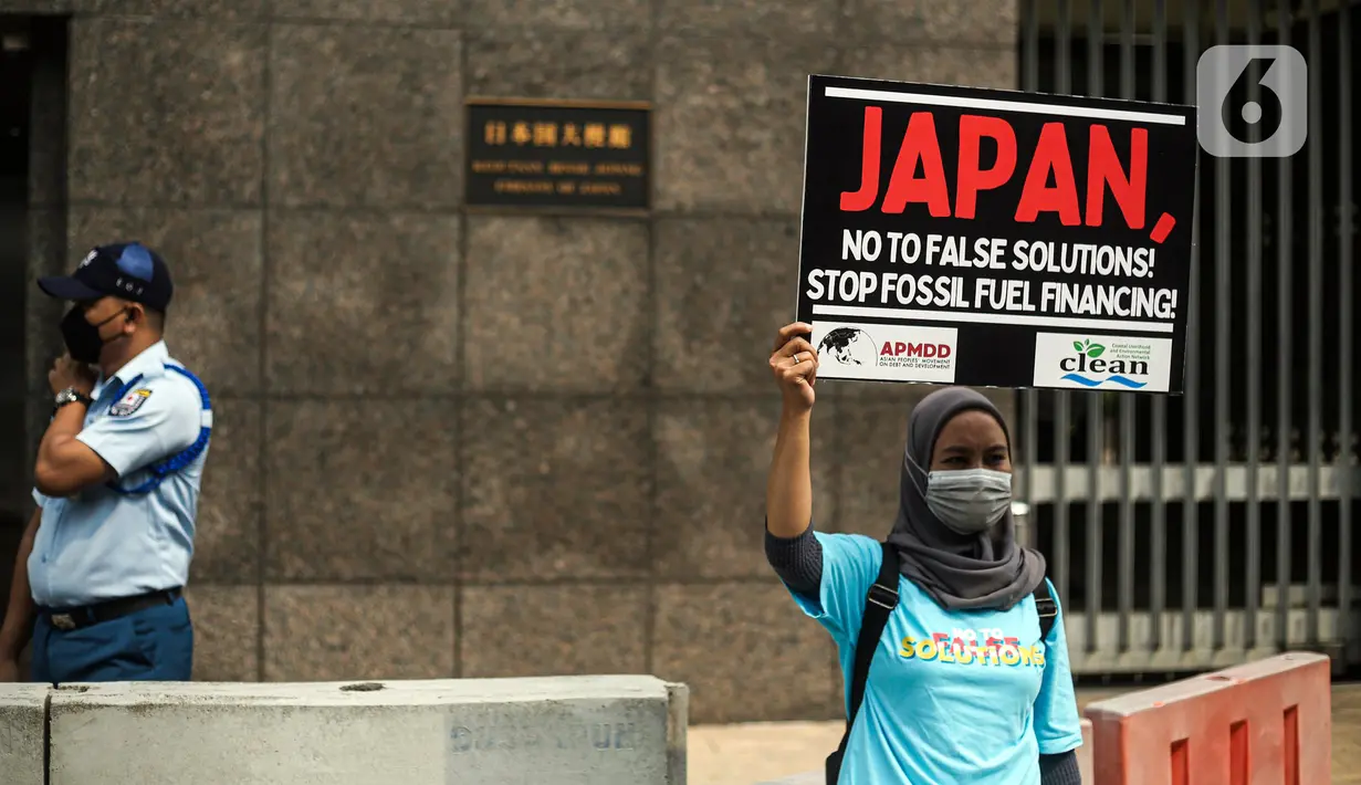 Seorang wanita yang tergabung dalam Walhi DKI menggelar aksi di depan Kedutaan Besar Jepang, Jakarta, Rabu (3/8/2022). Aksi simbolik tersebut bertepatan dengan pertemuan Japan Energy Summit di Tokyo yang masih memberikan solusi palsu mengatasi perubahan iklim. (Liputan6.com/Faizal Fanani)