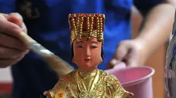 Proses pencucian patung dewa-dewi saat ritual cuci dewa di Klenteng Dharma Bhakti, Jakarta, minggu, (31/1). Pencucian sejumlah patung ini dilakukan guna menyambut tahun baru imlek China 2567. (Liputan6.com/Gempur M Surya)
