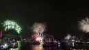 Kembang api meledak di Harbour Bridge dan Sydney Opera House, seperti yang terlihat dari Cahill Expressway selama perayaan Tahun Baru di Sydney, Rabu (1/1/2020). (Dean Lewins / AAP Images via AP)