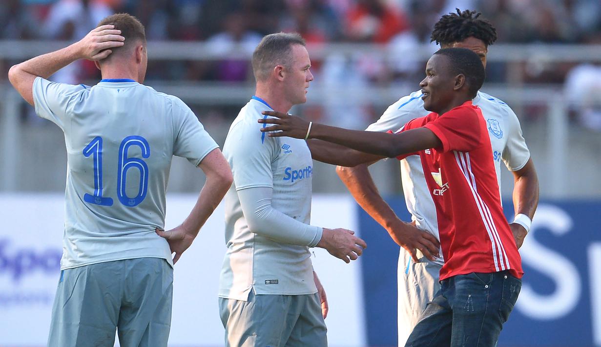 Ekspresi Rooney saat hendak dipeluk suporter pada laga persahabatan antara Everton dan Gor Mahia di SportsPesa Super Cup final di Dar-es-Salaam, (13/7/2017). (AFP/Tony Karumba)