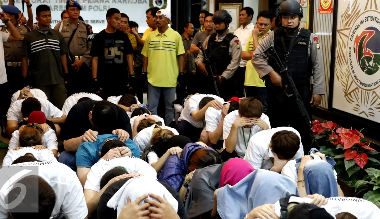 Satuan Polisi tiba di markas Bareskrim Mabes Polri membawa 30 WNA asal Taiwan dan 3 WNI hasil penggerebekan sebuah rumah di Desa Ciwaruga, Kecamatan Parongpong, Kabupaten Bandung Barat (KBB), Jakarta, Jumat (28/8/2015). (Liputan6.com/Yoppy Renato)