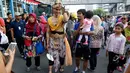 Karakter Brama Kumbara berinteraksi dengan warga saat pawai di area Car Free Day, Jakarta, Minggu (6/8). Pawai tersebut untuk mempromosikan sinetron laga Saur Sepuh The Series yang akan segera tayang di SCTV. (Liputan6.com/Fery Pradolo)