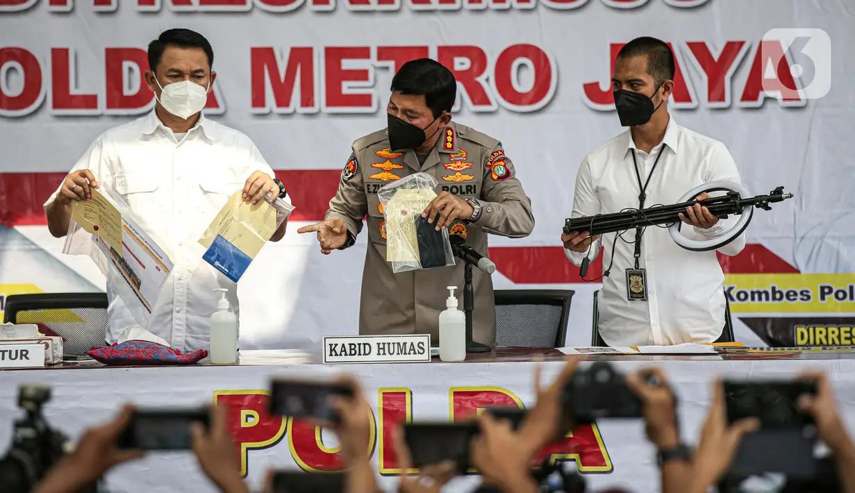 Kabid Humas Polda Metro Jaya, Kombes Pol Endra Zulpan menunjukkan barang bukti dalam rilis kasus penyebaran berita bohong atau hoaks di halaman Gedung Polda Metro Jaya, Jakarta, Kamis (28/7/2022). Dalam rilis tersebut dihadirkan satu tersangka penyebar hoaks dengan barang bukti tangkapan layar berupa ujaran kebencian dan hoaks media elektronik yang disebar melalui media sosial. (Liputan6.com/Faizal Fanani)