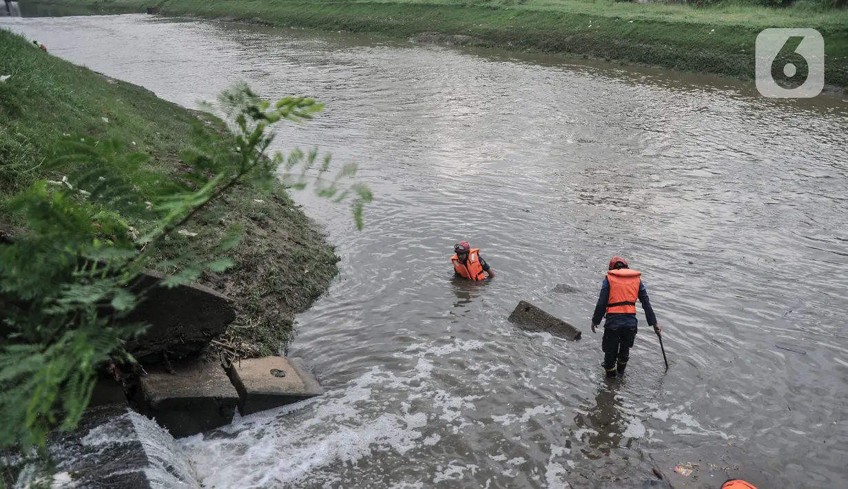Petugas SAR gabungan menyisir aliran kanal saat pencarian hari kedua korban tenggelam di Kanal Banjir Timur, Duren Sawit, Jakarta Timur, Selasa (2/11/2021). Pencarian berinisial ABP (9) diperluas menjadi radius 6 kilometer dari lokasi kejadian. (merdeka.com/Iqbal S. Nugroho)
