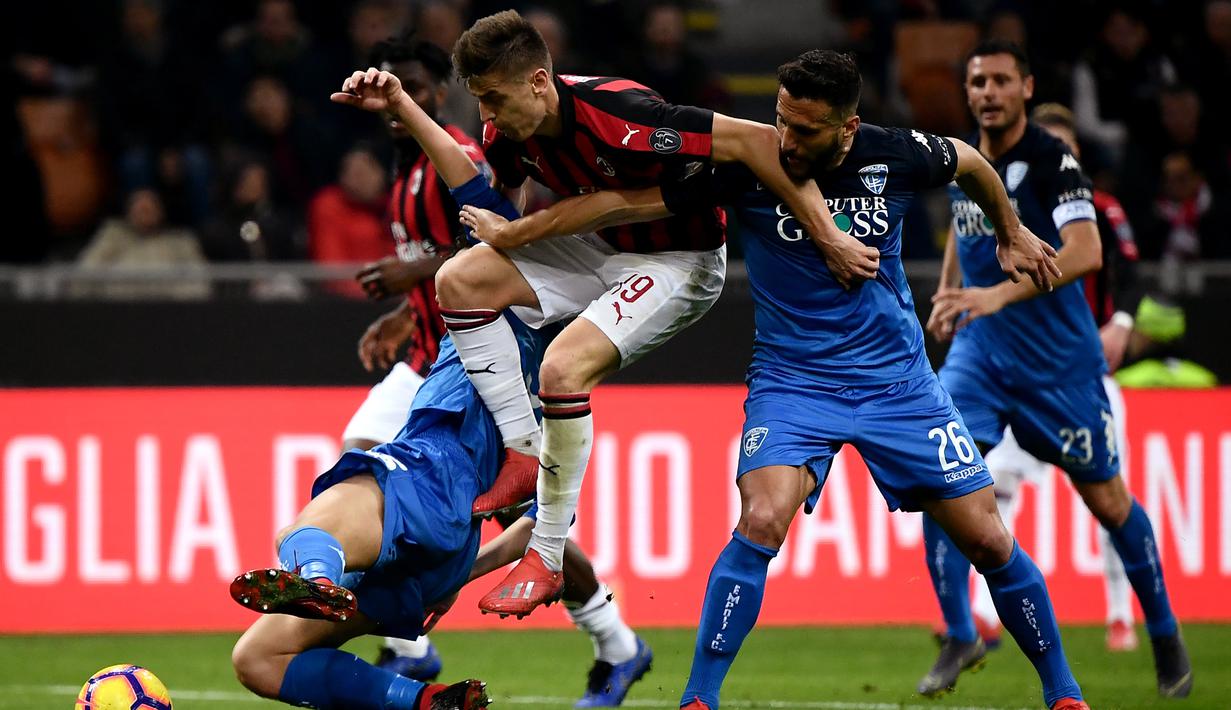 Striker AC Milan, Krzysztof Piatek, berebut bola dengan bek Empoli, Matias Silvestre, pada laga Serie A di Stadion San Siro, Milan, Jumat (22/2). Milan menang 3-0 atas Empoli. (AFP/Marco Bertorello)