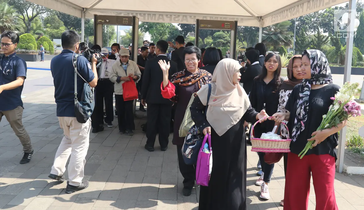 Petugas memeriksa warga yang akan masuk TMP Kalibata jelang pemakaman Presiden ke-3 RI BJ Habibie, Jakarta, Kamis (12/9/2019). Sejumlah petinggi negara dikabarkan bakal menghadiri pemakaman Habibie. (Liputan6.com/Immanuel Antonius)