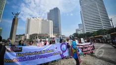 Aktivis dari Koalisi Masyarakat Menolak Swastanisasi Air Jakarta melakukan aksi Menolak Swastanisasi Air Jakarta di Bundaran HI, Jakarta, Minggu (22/3/2015). (Liputan6.com/Faizal Fanani) 