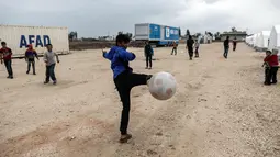 Sejumlah anak pengungsi Suriah bermain sepak bola di sebuah kamp di al-Bil, timur dari kota Azas yang dikuasai pemberontak di Suriah utara (21/4). (AFP Photo/Sameer Al-Doumy)