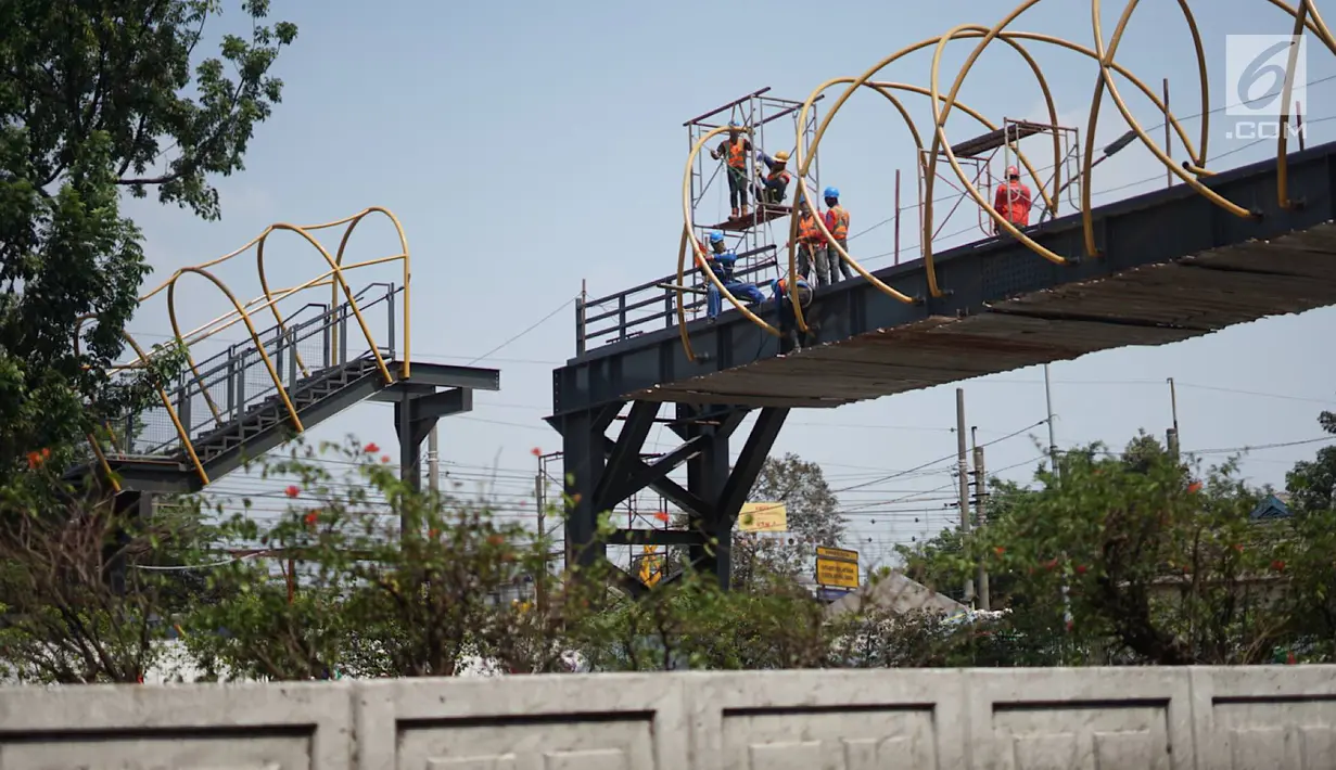 Pekerja menyelesaikan pembangunan Jembatan Penyebaran Orang (JPO) Pasar Minggu di Jakarta Selatan, Kamis (26/9/2019). JPO berdesain artistik senilai Rp 7 miliar tersebut ditargetkan rampung pengerjaannya pada Desember 2019 mendatang. (Liputan6.com/Immanuel Antonius)
