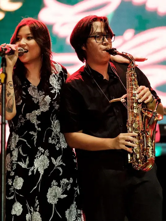 Dalam sebuah gig, Danilla Riyadi kenakan dress hitam yang manis dengan motif bunga putih [@danillariyadi]