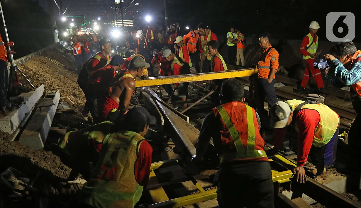 Sejumlah petugas merevitalisasi wesel rel di Stasiun KA Gambir, Jakarta, Kamis (14/2/2020) malam. PT KCI dan PT KAI Daop 1 Jakarta mengganti wesel rel di Stasiun Gambir dan Stasiun Jakarta Kota secara paralel yang akan berlangsung pada 13-23 Februari 2020. (Liputan6.com/Herman Zakharia)