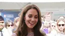 Kate Middleton tersenyum mencicipi bir lokal selama kunjungan ke Cambridgeshire County Day sebagai bagian dari perayaan Platinum Jubilee Ratu Elizabeth di Newmarket Racecourse (23/6/2022). (AFP/Pool/Paul Edwards)