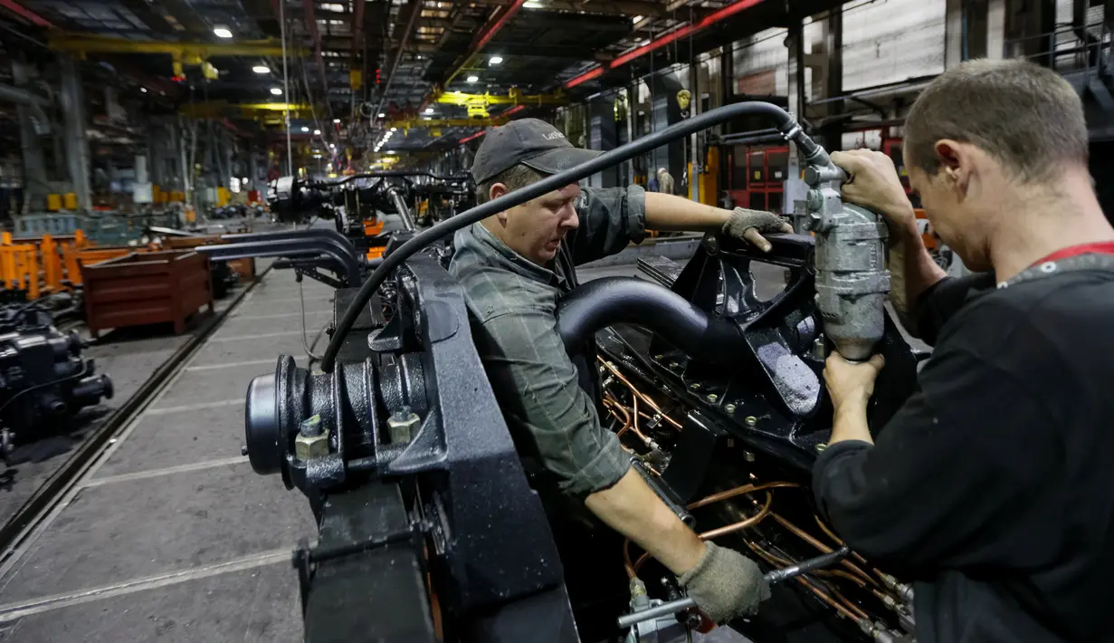 Sejumlah karyawan merakit truk lapis baja KrAZ-6322RA di Pabrik AutoKrAZ, Kremenchuk, Ukraina, Selasa (14/6). Truk ini juga dapat membawa penumpang dan mengangkut artileri perang. (REUTERS / Valentyn Makarenko)