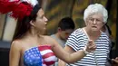 Seorang wanita dengan bertelanjang dada dipinggiran ruas jalan Times Square, New York,AS,  Selasa (18/8/2015). Mereka meminta uang kepada para wisatawan yang ingin mengajak foto bersama dengan tanpa memakai busana. (REUTERS/Carlo Allegri)