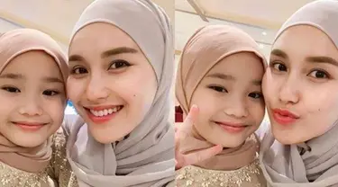 Ayu Ting Ting selalu memperhatikan penampilannya. Seperti tampil anggun dengan berhijab. Tak sendiri, momen Ayu Ting Ting berhijab bersama sang buah hati juga curi atensi. Bilqis terlihat menawan dengan pakai hijab. (Liputan6.com/IG/ayutingting92)