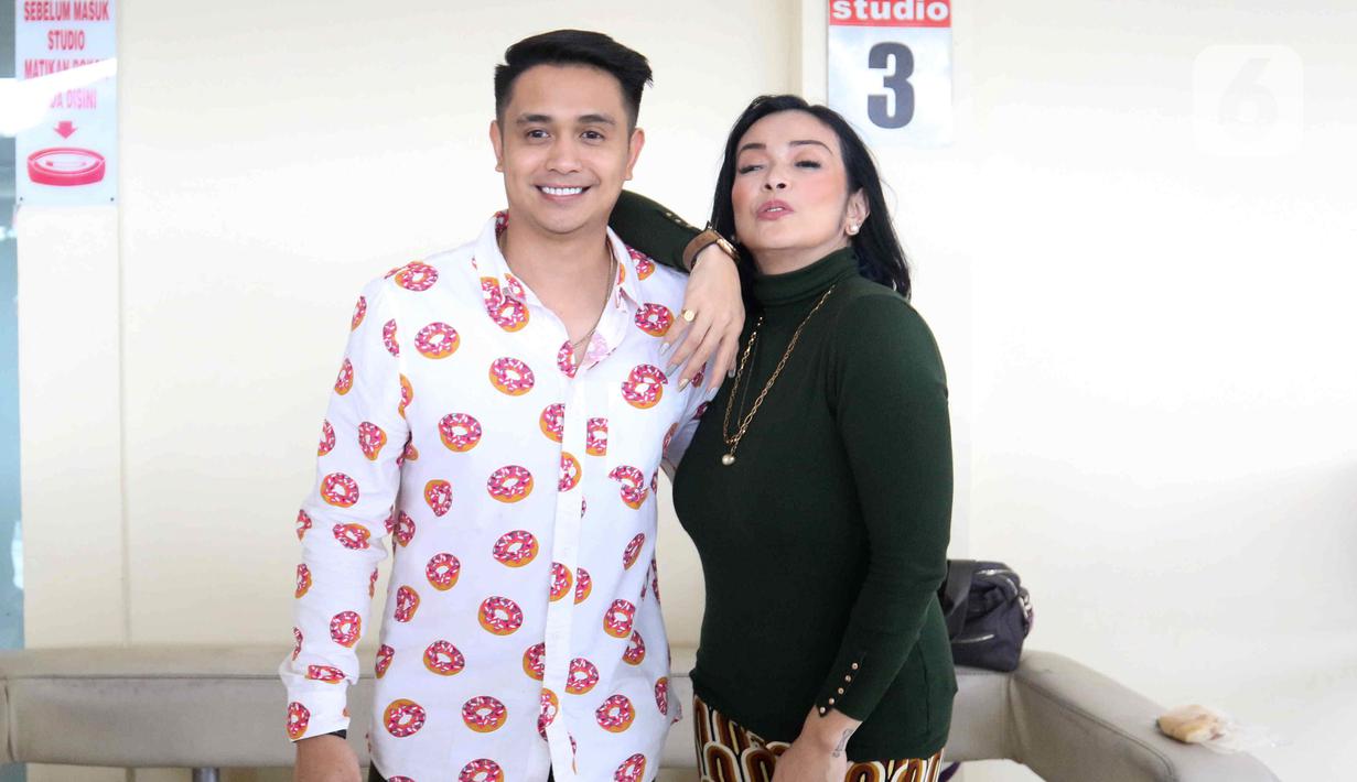 Pasangan selebritis Ajun Perwira dan Jennifer Jill berpose di kawasan Cipinang Cempedak, Jakarta, Selasa (9/8/2022). Istri dari artis Ajun Perwira, Jennifer Jill belum lama ini membagikan potret bahagia karena berhasil menurunkan berat badan hingga 24 kilo selama satu tahun. (Liputan6.com/Herman Zakharia)