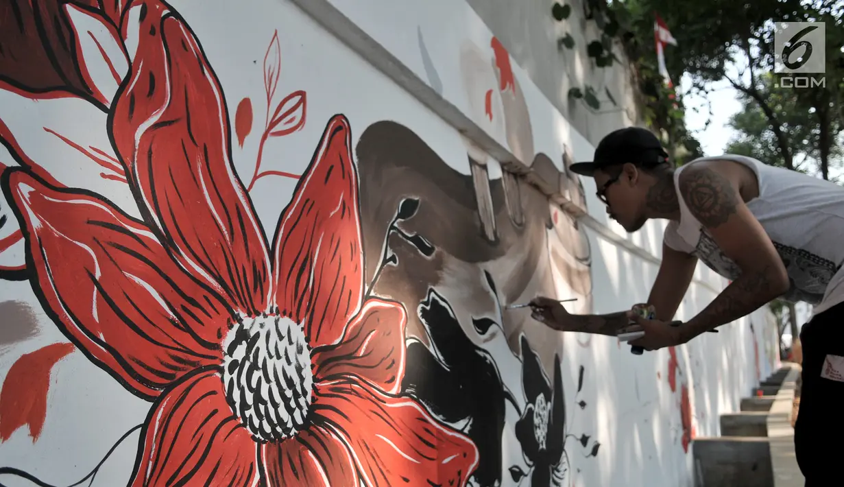 Seniman dari Reflect menyelesaikan mural berjudul Gugur Bunga dalam acara Project #1/Mural Cikini di Taman Plaza Teater Besar, TIM, Jakarta, Selasa (20/8/2019). Mural tersebut digelar dalam rangka menata estetika ruang publik sebagai sarana interaksi visual. (merdeka.com/Iqbal S. Nugroho)