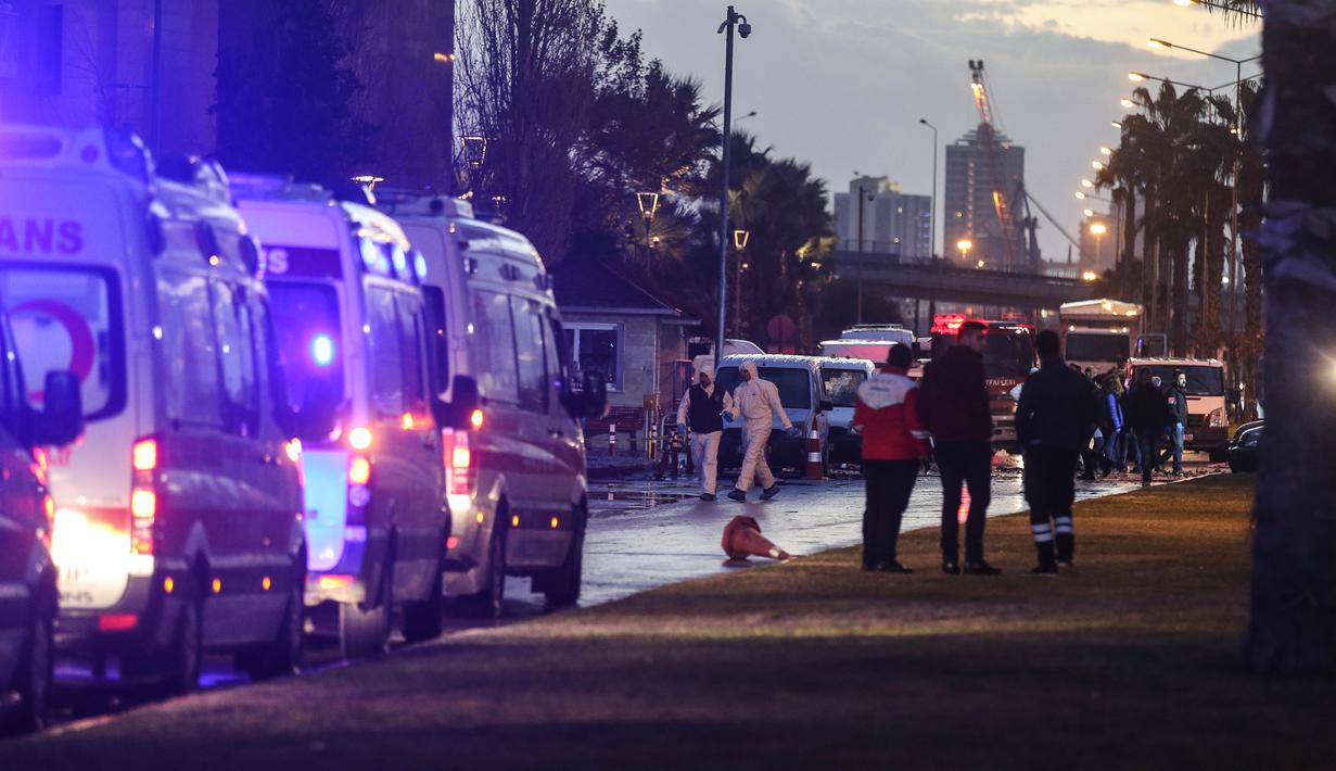 Petugas forensik melakukan penyelidikan di lokasi ledakan bom mobil yang terjadi di luar sebuah pengadilan di kota Izmir, wilayah barat Turki, Kamis (5/1). Dua penyerang dikabarkan tewas dalam baku tembak dengan pasukan keamanan. (AFP PHOTO/Emre TAZEGUL)