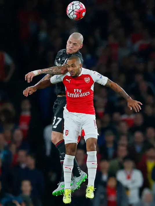 Gelandang Arsenal, Theo Walcott (kanan) berebut bola udara dengan bek Liverpool, Martin Skrtel Chambers dalam pertandingan Liga Primer Inggris di Stadion Emirates, Inggris, (24/8/2015). Kedua tim bermain imbang dengan skor 0-0. (Reuters/Eddie Keogh)