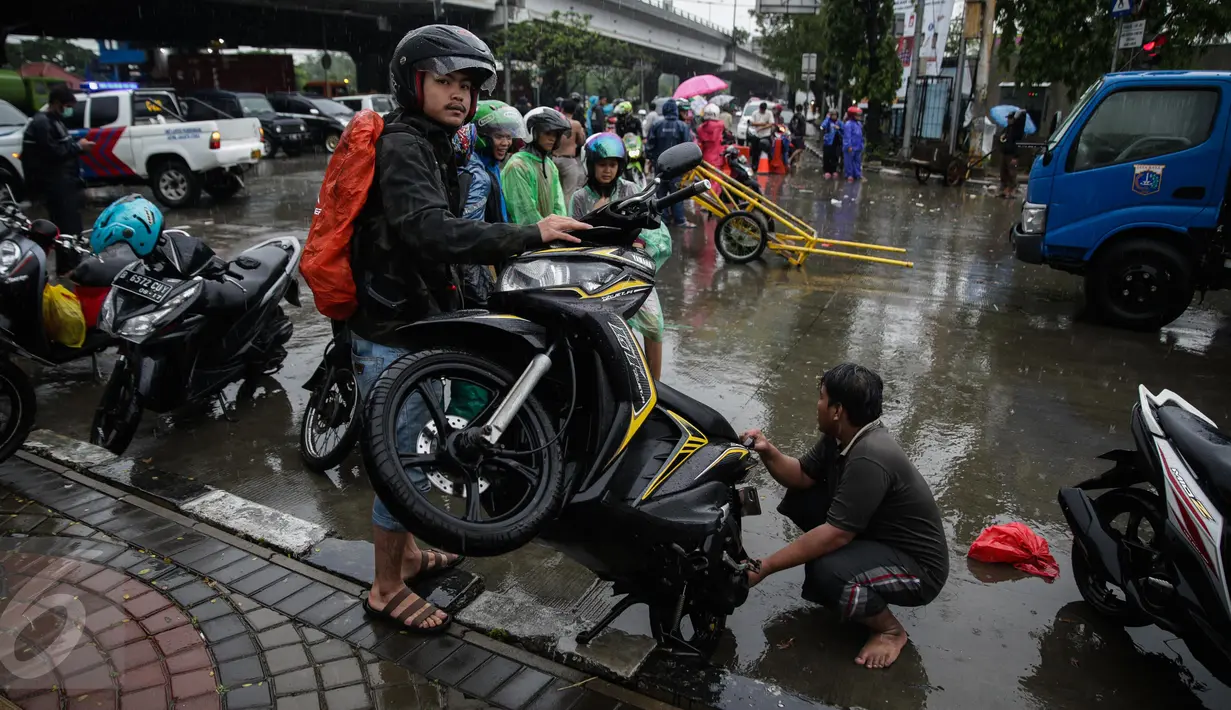 Sejumlah kendaran mengalami mogok usai memaksakan melintas air banjir di jalan Gunung Sahari menuju Ancol, Jakarta, Selasa (21/2). Hujan deras sejak malam tadi, membuat sejumlah wilayah Jakarta tergenang air banjir. (Liputan6.com/Faizal Fanani)