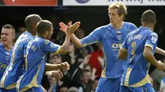 Portsmouth's striker Peter Crouch celebrates scoring his first goal during their Premier League match against Everton at Fratton Park in Portsmouth, on March 21, 2009. AFP PHOTO/Glyn Kirk