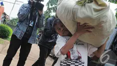 Sony Wakwaw membawa barangnya saat pindah rumah. Foto diambil pada Kamis (4/12/2014). (Liputan6.com/Herman Zakharia)