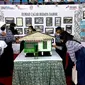 Miniatur rumah Dahor beserta foto sejarah yang ditampilkan dalam pameran Pekan Kebudayaan Daerah Kaltim 2022. (Liputan6.com/Istimewa)