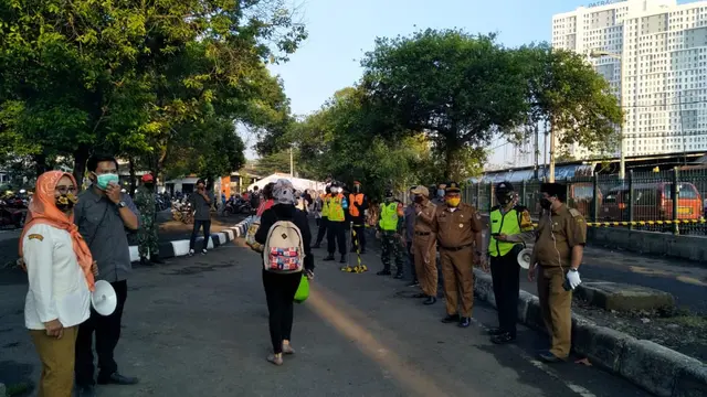 Petugas gabungan menggelar razia masker scuba dan buff terhadap penumpang KRL di Stasiun Bekasi.