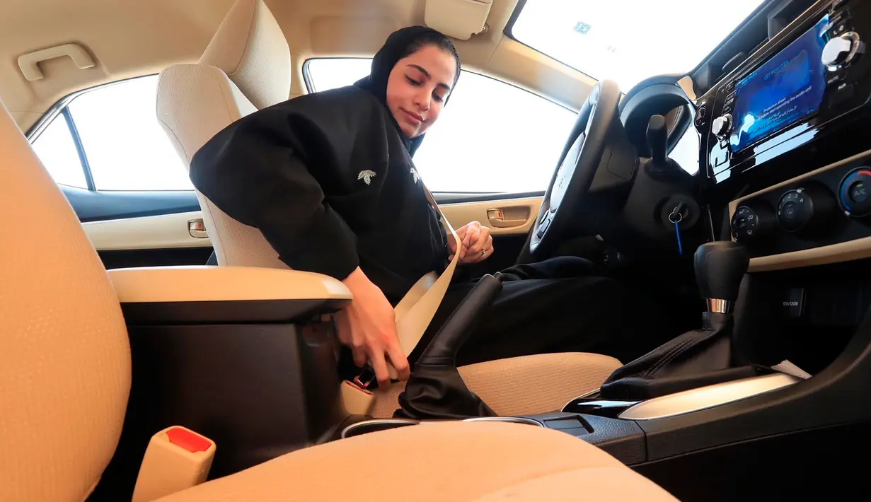 Seorang wanita mengenakan sabuk pengaman sebelum ujian mengemudi di Departemen Lalu Lintas Umum di ibu kota Riyadh, Senin (4/6). Pemerintah Arab Saudi resmi mengeluarkan lisensi mengemudi untuk para wanita di sana. (Saudi Information Ministry via AP)