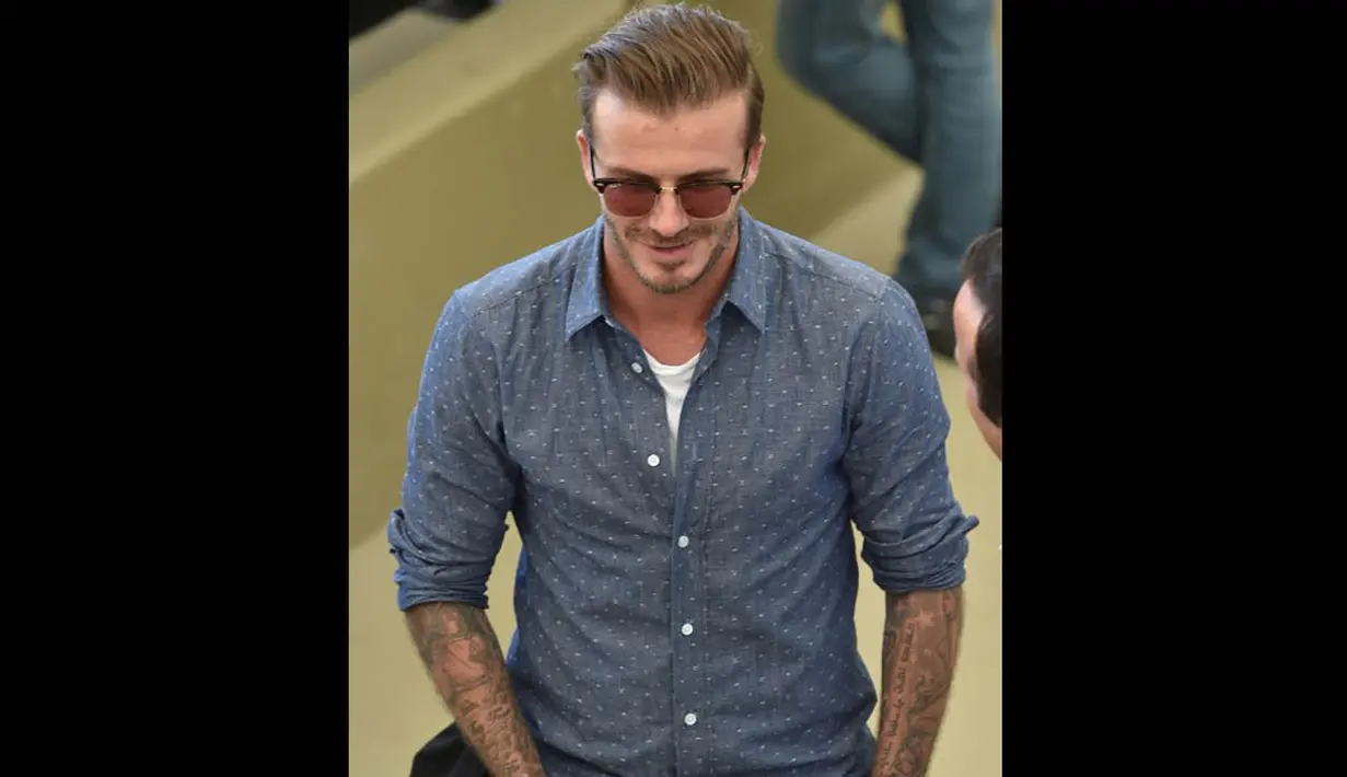 Mantan pesepakbola asal Inggris, David Beckham saat menyaksikan pertandingan final piala dunia, Brasil Senin (14/7/14). (AFP PHOTO/Nelson Almeida)