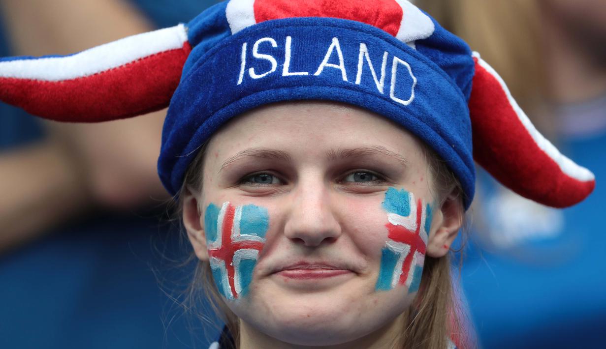 Senyum manis fans Islandia saat menonton timnya melawan Austria pada grup F Euro Cup 2016 di Stadion Stade de France, Saint-Denis, Kamis (23/6/2016) dini hari WIB. (AFP/Kenzo Tribouillard)