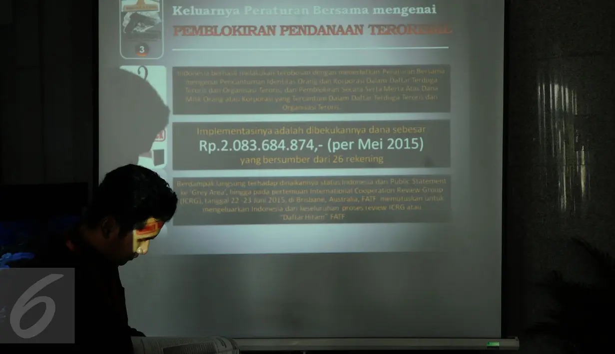 Seseorang melintas di depan proyektor usai pemaparan kinerja PPATK selama 2015 di Gedung PPATK Jakarta, Senin (28/12/2015). PPATK mengungkap 289 hasil analisis keuangan yang terindikasi pidana korupsi dan pencucian uang. (Liputan6.com/Helmi Fithriansyah)