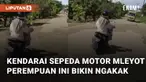 Aksi seorang perempuan kendarai sepeda motor mleyot menarik perhatian