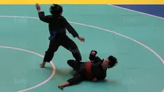 Octaviani Nirmalasari (kanan) mencoba menjatuhnkan lawannya asal Laos, Olahthai Sounthavong pada semifinal Test Event Pencak Silat 2018 di Padepokan Silat TMII, Jakarta, (12/2/2018). Oktaviani menang 5-0. (Bola.com/Nick Hanoatubun)
