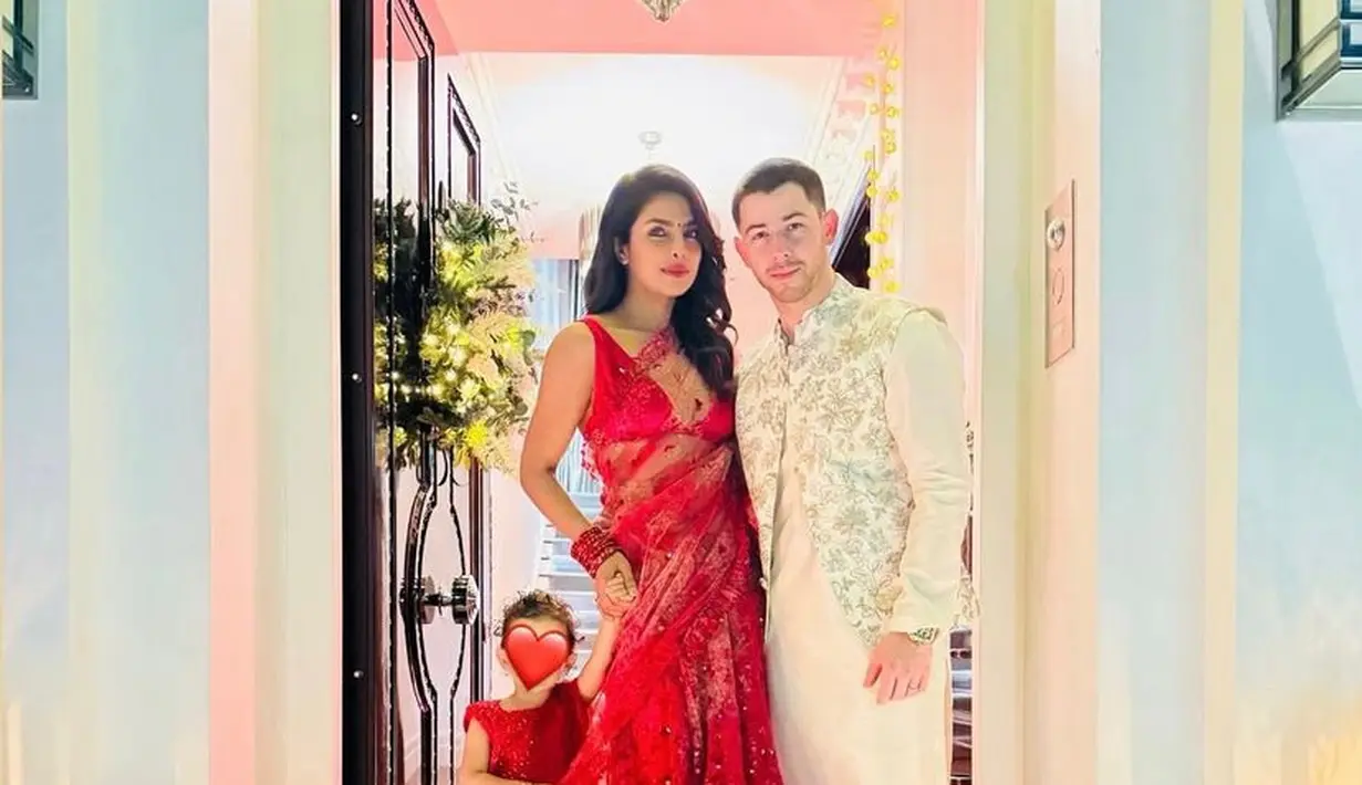 Priyanka Chopra tampil dengan saree merah, terdiri dari atasan sleeveless dipadukan selendang transparan dan rok yang dihiasi payetan. [@priyankachopra]