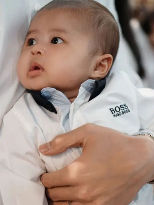 Keluarga ini terlihat kompak mengenakan busana serba warna putih. Raphael sendiri terlihat menggemaskan dengan pipinya yang tembem. (Foto: instagram.com/sandradewi88)