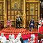 Pangeran Charles dari Inggris, Pangeran Wales (ke-2 dari kanan) membacakan Pidato Ratu saat ia duduk di dekat Mahkota Negara Bagian (kedua dari kiri), Camilla dari Inggris, Duchess of Cornwall (kanan) dan Pangeran William, Duke of Cambridge dari Inggris (kiri) di chamber House of Lords, selama Pembukaan Parlemen Negara, di Gedung Parlemen, di London, pada 10 Mei 2022. (ARTHUR EDWARDS / POOL / AFP)