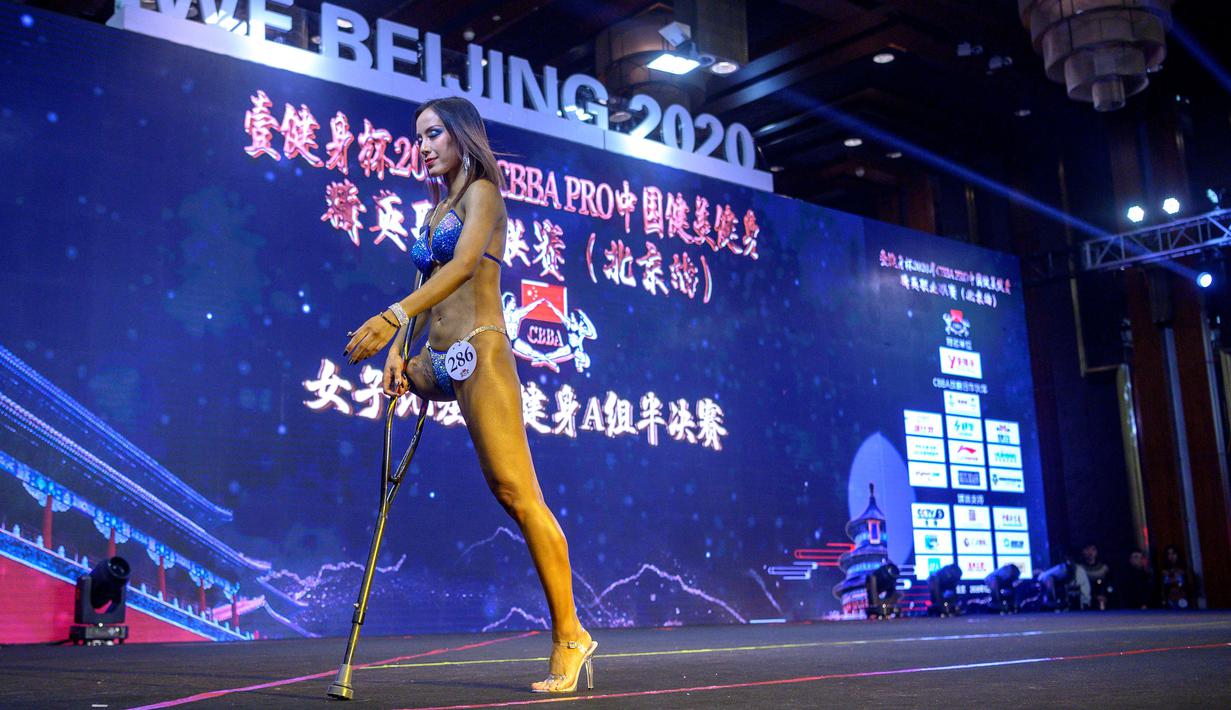Atlet Binaraga asal China, Gui Yuna saat berada dipanggung dalam ajang International Weightlifting Federation (IWF) Beijing 2020 di Beijing, China, Jumat (11/12/2020). (AFP/NOEL CELIS)