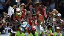 Pendukung dari petenis Jepang, Kei Nishikori merayakan kemenangannya atas Rusia Andrey Kuznetsov setelah pertandingan putaran pertama tunggal putra Australian Open 2017 di Melbourne, Australia (16/1). (AFP Photo/Paul Crock)