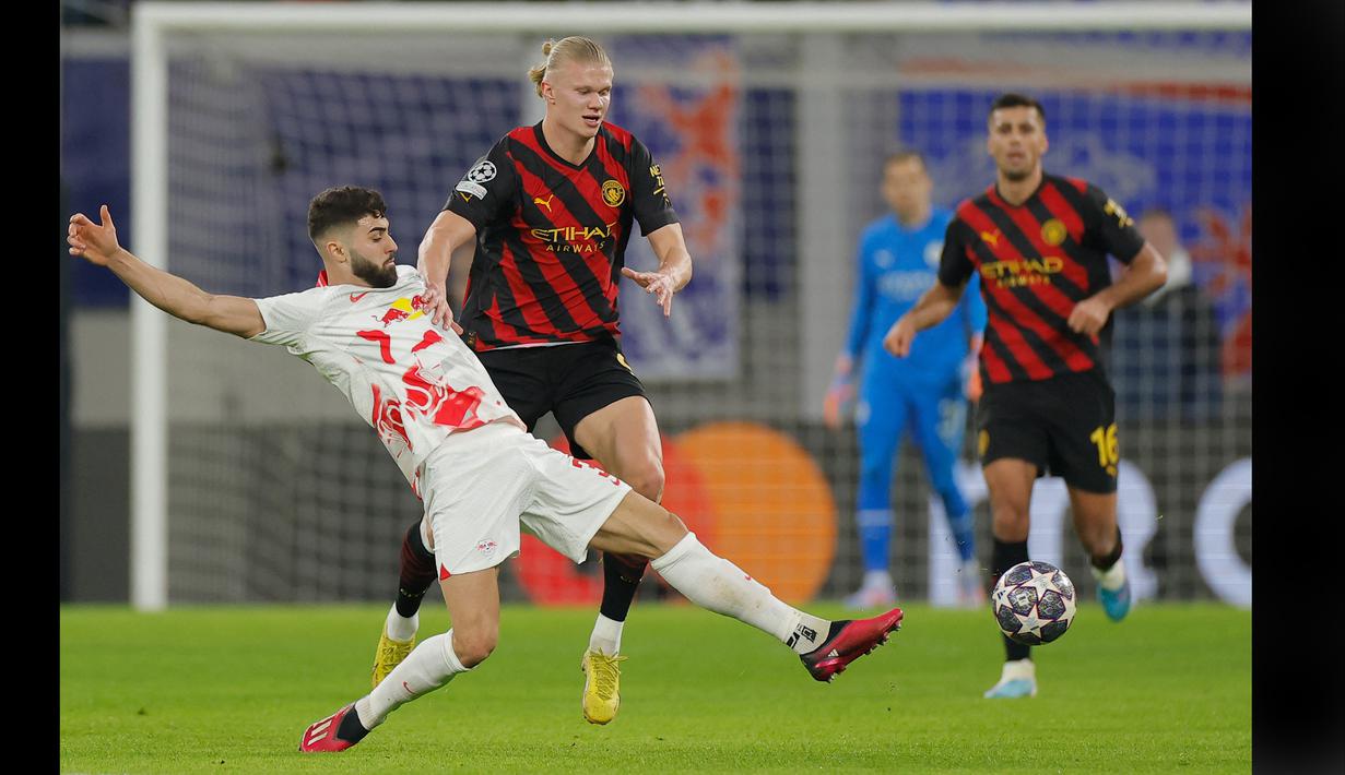 Pemain Manchester City, Erling Haaland berebut bola di udara dengan bek RB Leipzig, Josko Gvardiol (kiri) dalam pertandingan leg pertama babak 16 besar Liga Champions 2022/2023 antara RB Leipzig melawan Manchester City yang berlangsung di Red Bull Arena, Kamis (23/2/2023). (AFP/Odd Andersen)