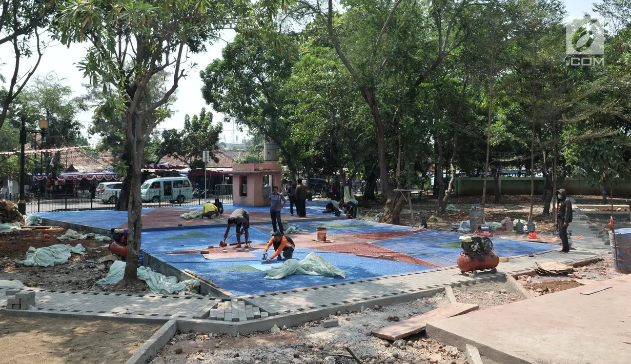 Pekerja menyelesaikan pemasangan batu berpori di Taman Gorontalo, Tanjung Priok, Jakarta, Senin (19/8/2019). Gubernur DKI Jakarta Anies Baswedan menargetkan pembangunan 53 Taman Maju Bersama yang tersebar di Jakarta rampung pada Desember 2019. (merdeka.com/Iqbal Nugroho)