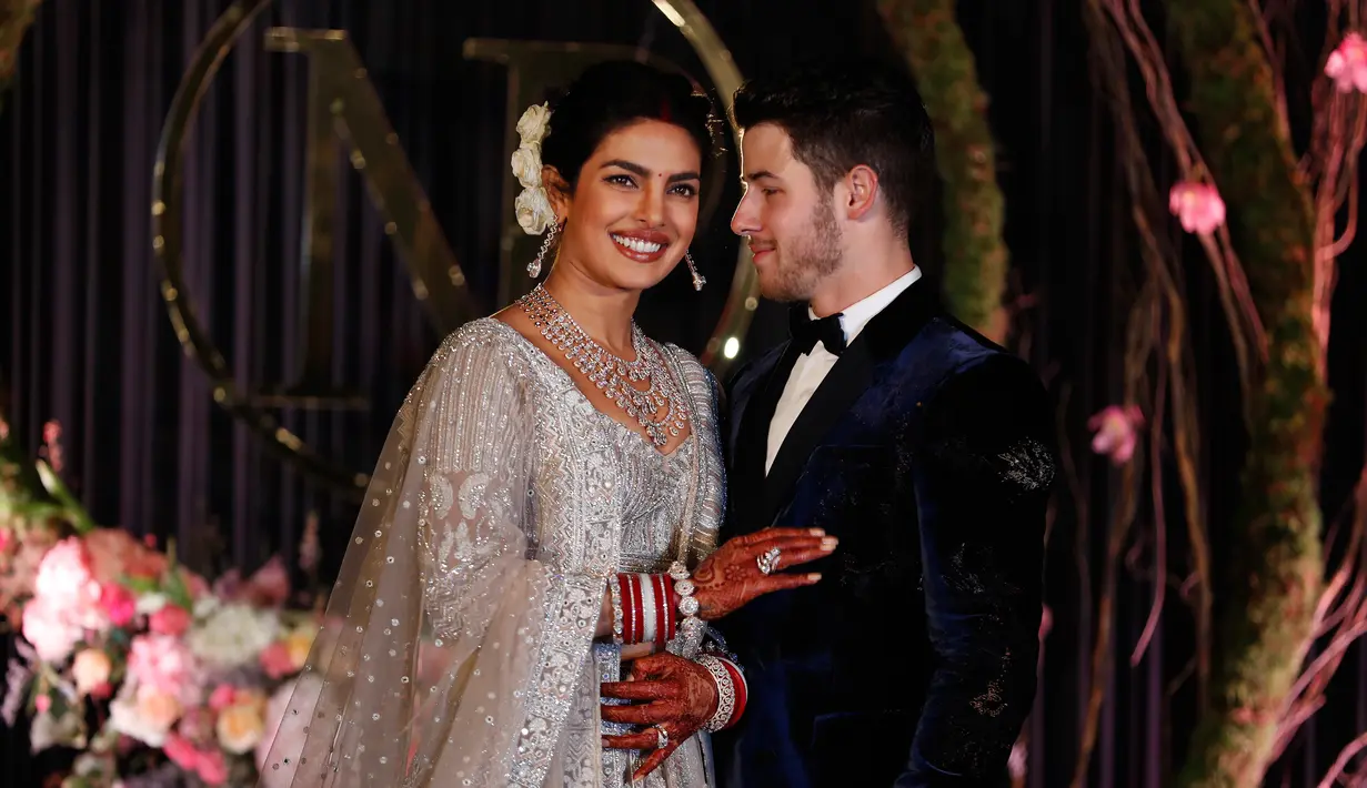 Aktris Bollywood Priyanka Chopra dan musisi AS Nick Jonas berpose saat resepsi pernikahan mereka di New Delhi, India, Selasa (4/12). Pada 1 Desember 2018, mereka menikah secara Kristen. (AP Photo/Altaf Qadri)