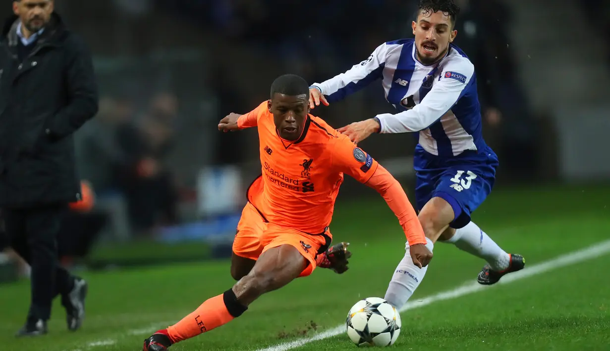 Pemain Liverpool, Georginio Wijnaldum berebut bola dengan pemain FC Porto, Alex Telles dalam leg pertama babak 16 besar Liga Champions di Stadion Do Dragao, Kamis (15/2). Liverpool sukses menundukkan Porto dengan skor 5-0. (AP/Luis Vieira)
