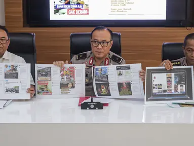 Karopenmas Divisi Humas Polri Brigjen Pol Dedi Prasetyo (tengah) dan Kasubdit I Dittipidsiber Bareskrim Polri Kombes Pol Dani Kustoni (kiri) menunjukkan barang bukti kasus pemberitaan hoax di Divhumas Mabes Polri, Jakarta, Senin (1/7/2019). (Liputan6.com/Faizal Fanani)