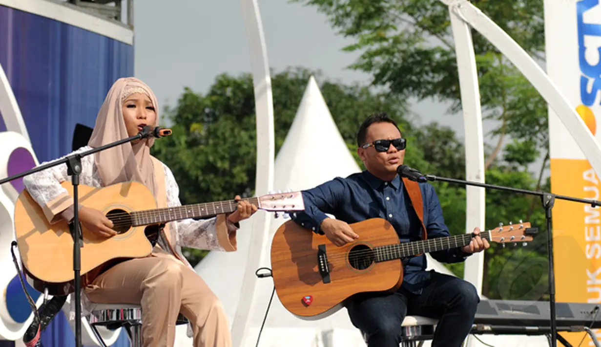 Juara Music Video Contest, Wiwi Handayani (kiri) berduet bersama Badai 'Kerispatih' di panggung inBox SCTV di Cibinong, Bogor, Jumat (30/1). Wiwi Handayani tampil sebagai pemenang setelah videonya mendapat 21.958 likes. (Liputan6.com/Helmi Fithriansyah)