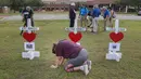 Penduduk Santa Fe, Lori Simmons menangis di depan salib saat acara mengheningkan cipta di depan SMA Santa Fe di Texas, AS, Senin (21/5). Pelaku penembakan Texas memakai senapan dan pistol untuk menembaki korban. (Steve Gonzales/Houston Chronicle via AP)