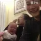 Bayi yang tertawa melihat ayahnya menghitung uang. (Weibo)