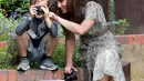 Duchess of Cambridge Kate Middleton bersama seorang anak saat ikut serta belajar fotografi dengan Action for Children di Kingston upon Thames, Inggris (25/6/2019). (AFP Photo/Chris Jackson)